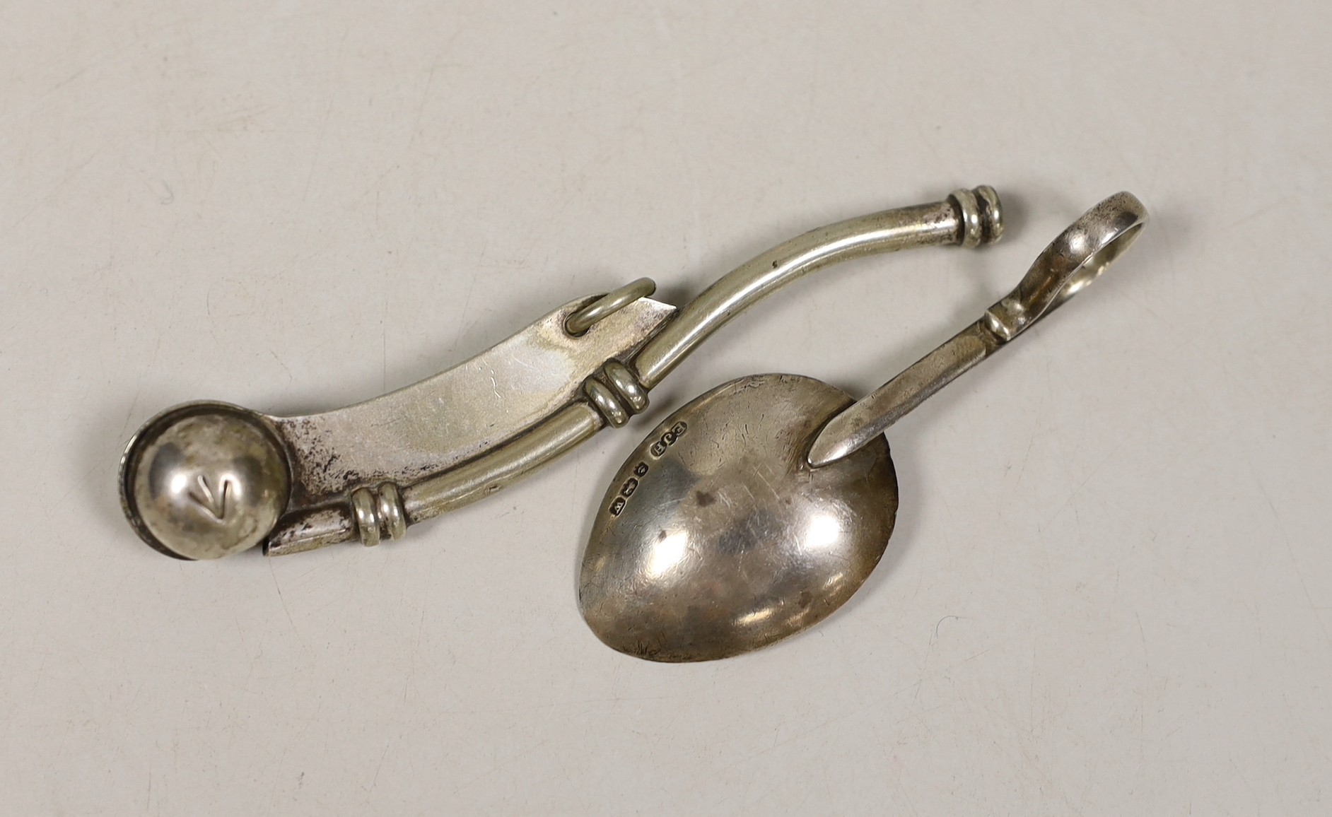 A George V silver caddy spoon and a plated bosun’s whistle.